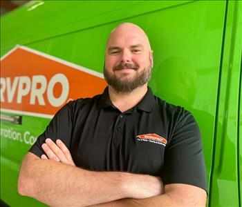 Project Manager Standing in front of Servpro Fleet